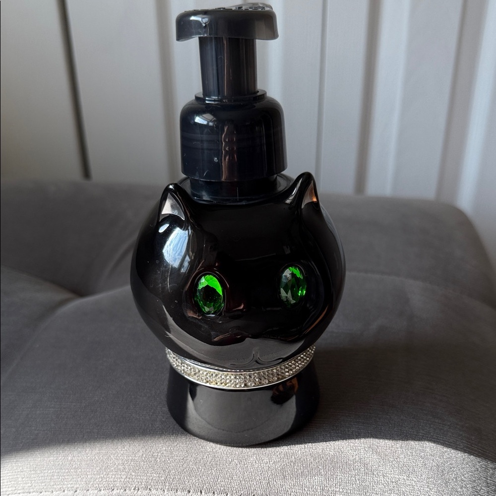 Black Cat-Shaped Soap Dispenser with Green Eyes gems. Some gems are missing